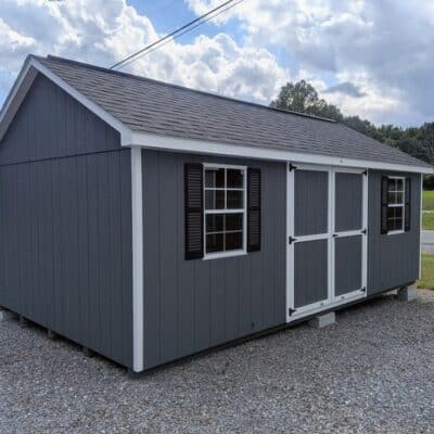12 x 20 size painted classic style shed with gray siding, white trim, black architectural shingle roof, black shutters, (2) 10' ridge vents, ggs 6 foot double doors, two windows.