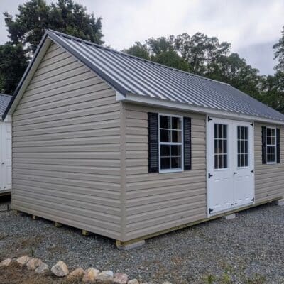12 x 20 size vinyl garden style shed with clay siding, white trim, black metal roof, black shutters, fiber 9 lite 6 foot double shed doors, two windows.