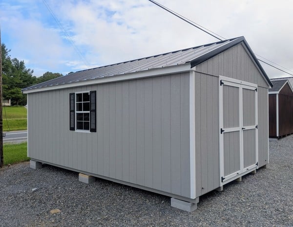 12 x 20 size painted a-roof style shed with gap gray siding, white trim, black metal roof, black shutters, legacy metal roof style, ggs 6 foot double doors, two windows.