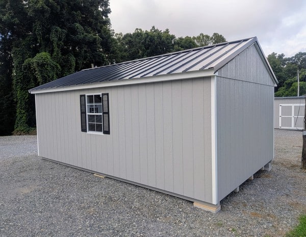 12 x 20 size painted a-roof style shed with gap gray siding, white trim, black metal roof, black shutters, legacy metal roof style, ggs 6 foot double doors, two windows.
