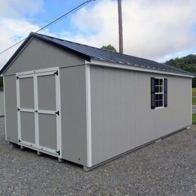 12 x 20 size painted a-roof style shed with gap gray siding, white trim, black metal roof, black shutters, legacy metal roof style, ggs 6 foot double doors, two windows.