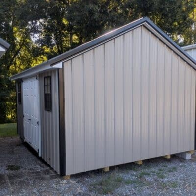 12x16 size metal classic style shed with white trim, clay metal siding, black metal roof, corners and j channel, 6 foot fiber double shed doors with two black windows.