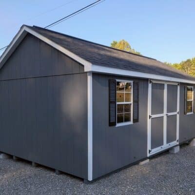 12 x 20 size painted classic style shed with gray siding, white trim, black architectural shingle roof, black shutters, (2) 10' ridge vents, ggs 6 foot double doors, two windows.
