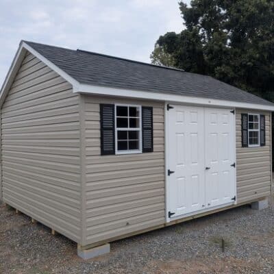 12x16 size vinyl classic style shed with clay siding, white trim, black architectural shingle roof, black shutters. has (1) 10' ridge vent, fiber solid 6 foot double doors and two windows