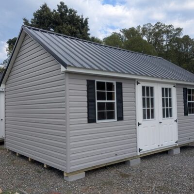 12 x 20 size vinyl garden style shed with flint siding, white trim, black metal roof, black shutters, fiber 9 lite 6 foot double shed doors, two windows.