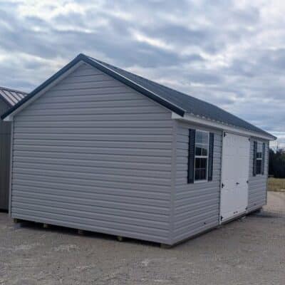 12 x 20 size vinyl classic style shed with flint siding, white trim, black metal roof, black shutters, fiber solid 6 foot double shed doors, two windows.